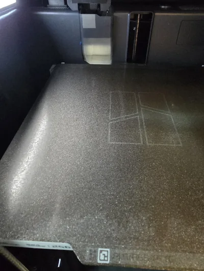 3D printer build plate showing first-layer marks