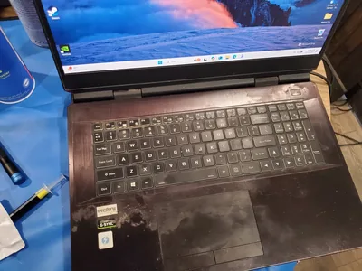 Gaming laptop on a cleaning mat before internal servicing