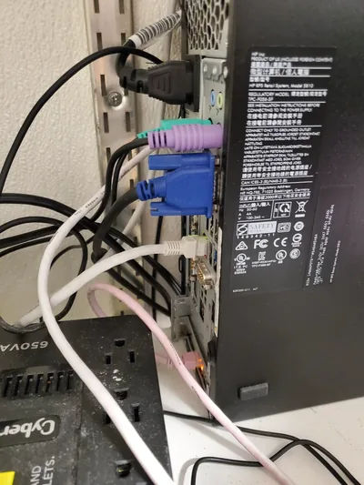 Rear of a retail point-of-sale terminal above a CyberPower battery backup