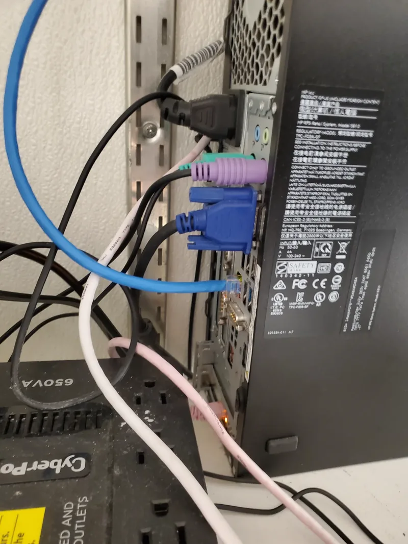 Rear of a retail point-of-sale terminal above a CyberPower battery backup