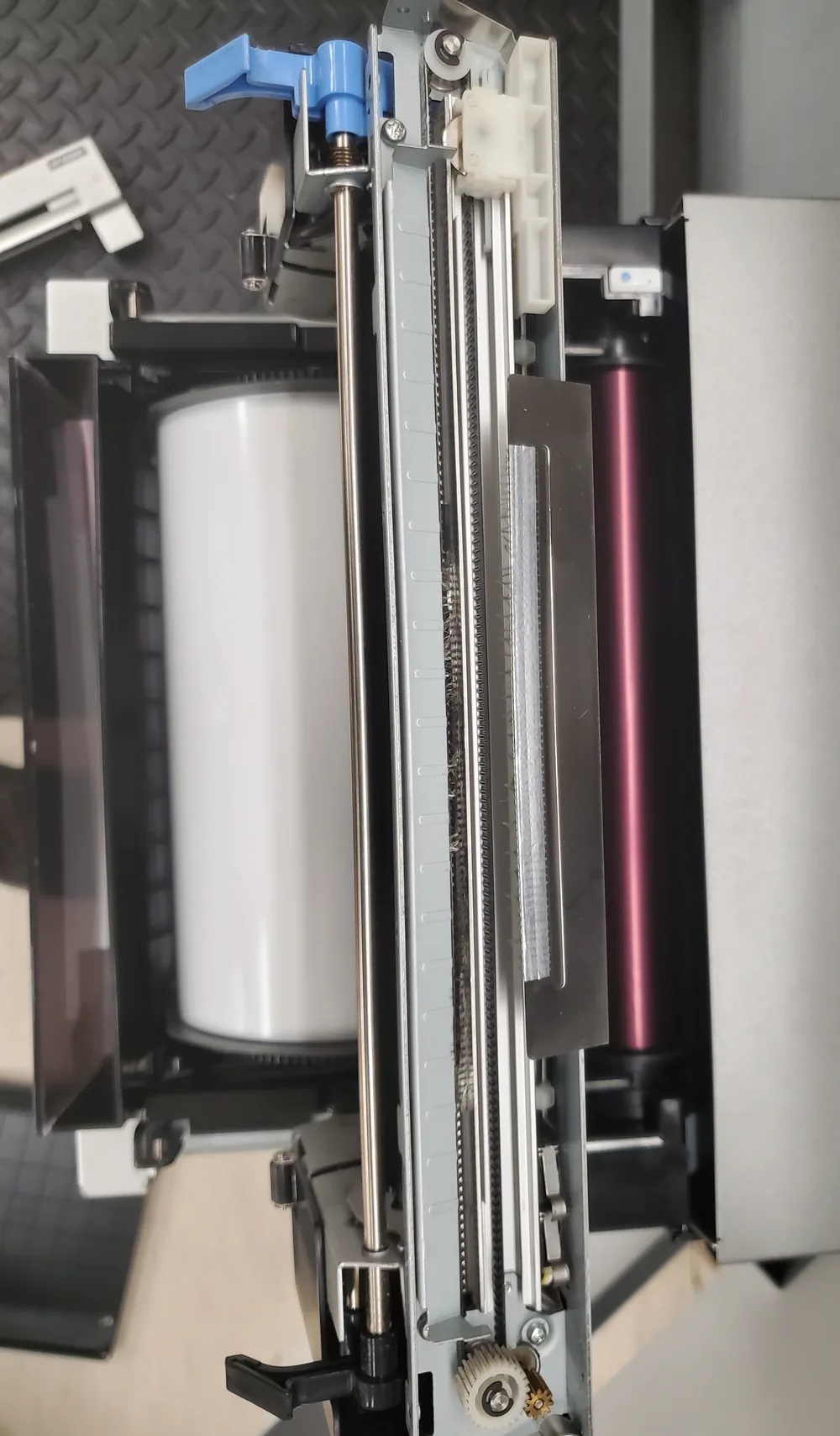 Ribbon spool and print carriage inside a dye-sublimation printer