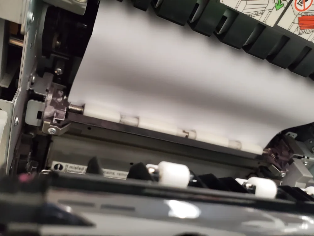 Sheet held in the transport rollers of a laser printer